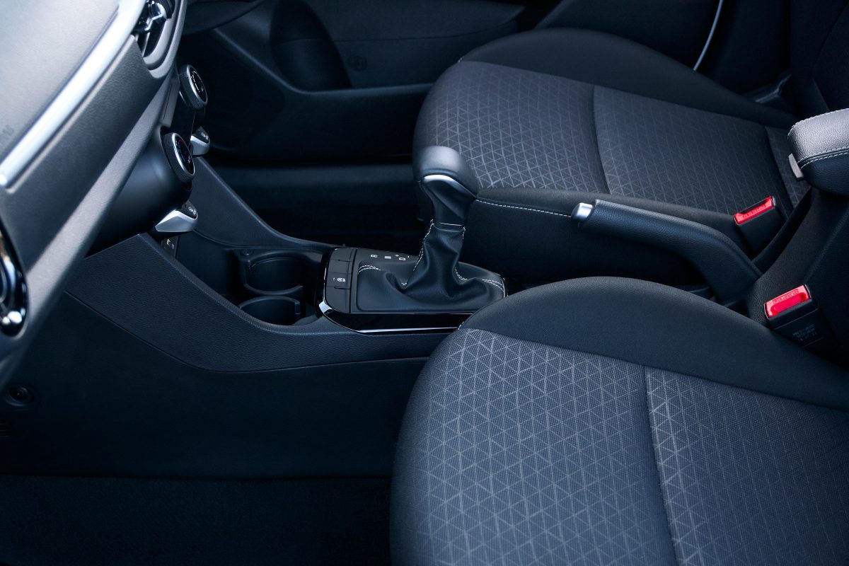 Close-up view of a sleek and modern car interior featuring a gear lever and stylish seats.